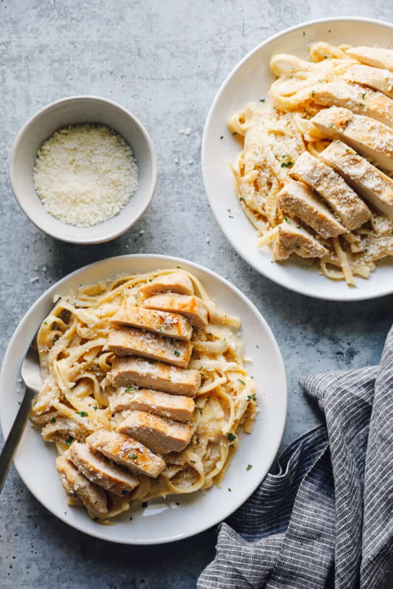 plates of instant pot chicken Alfredo on a table top