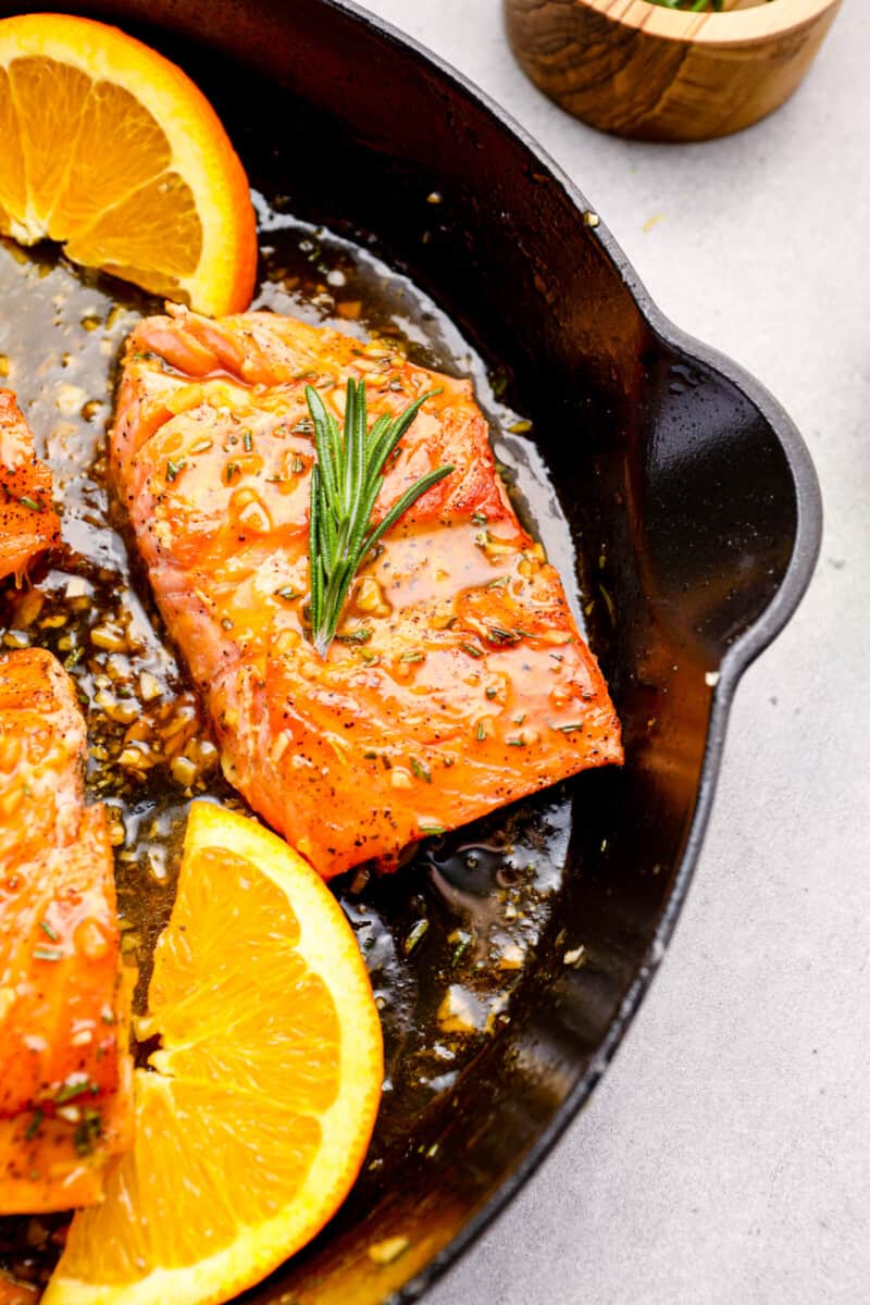 close up on a skillet with glazed salmon