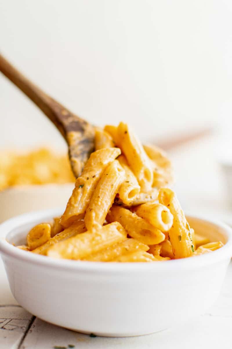 fork digging into a bowl of penne alla vodka