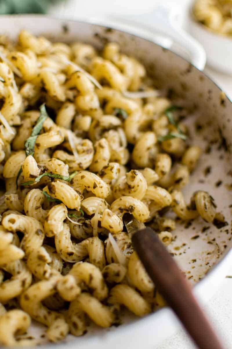 close up on pesto cavatappi in a skillet