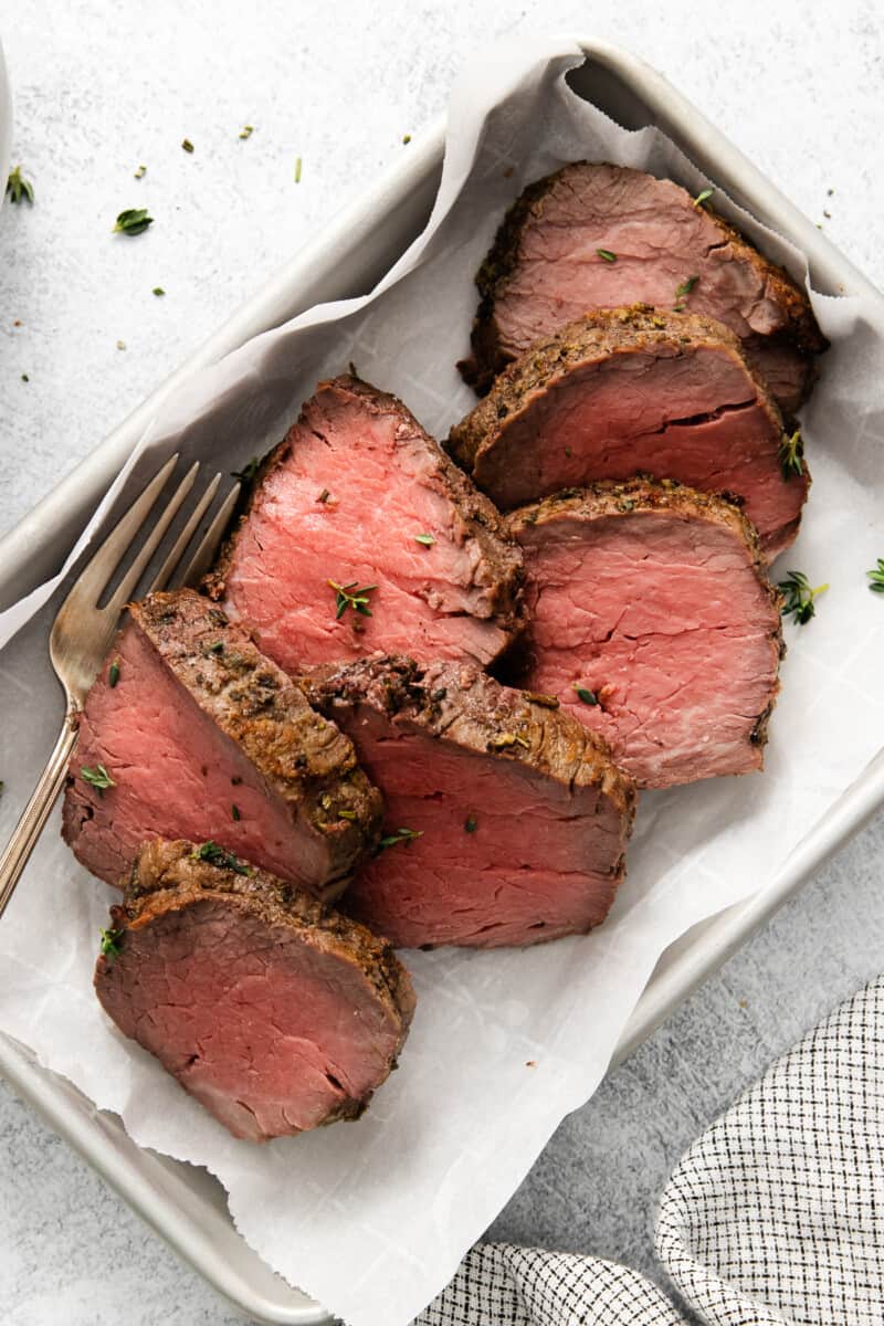 a tray of beef tenderloin sliced viewed from above