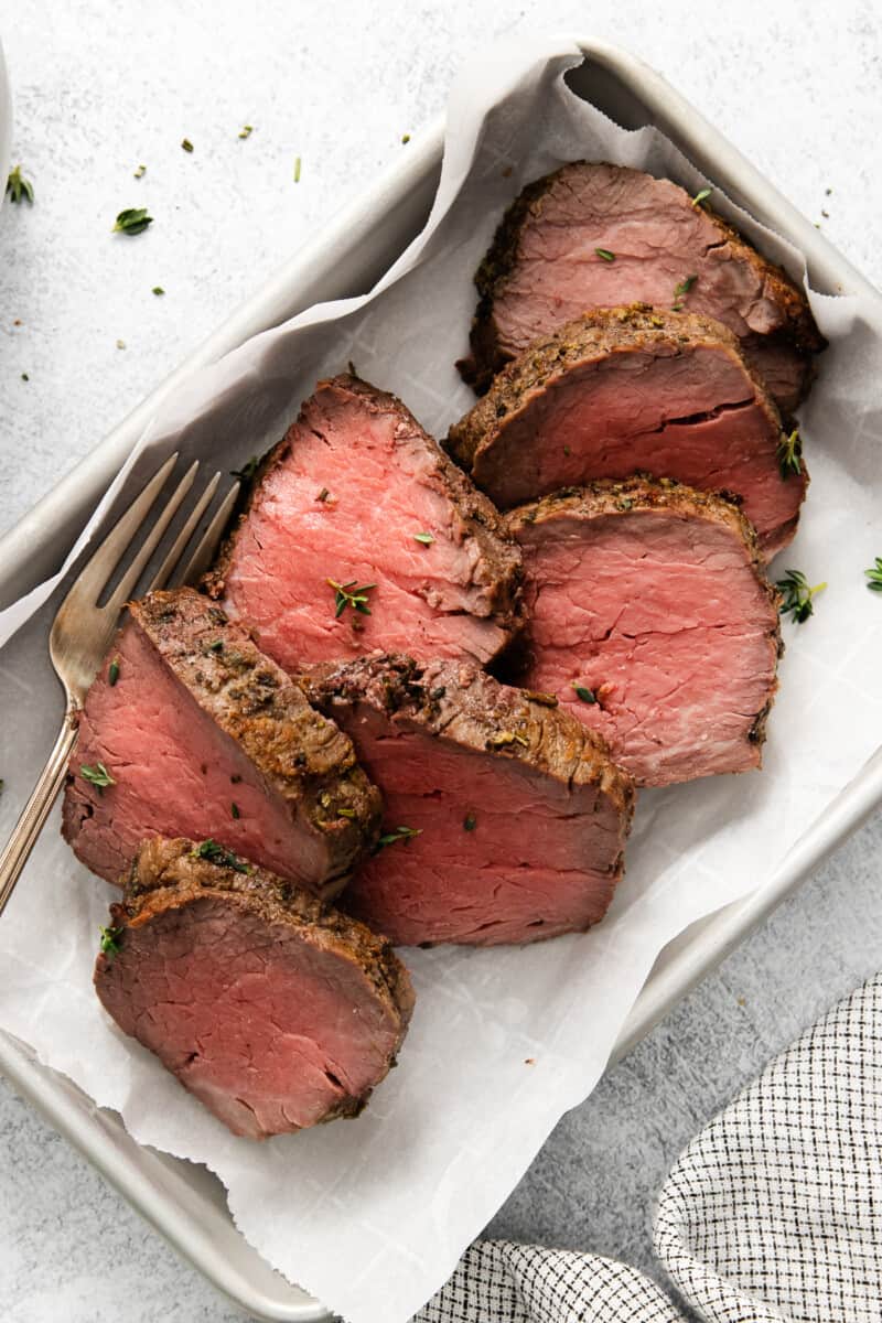 a tray of beef tenderloin sliced viewed from above