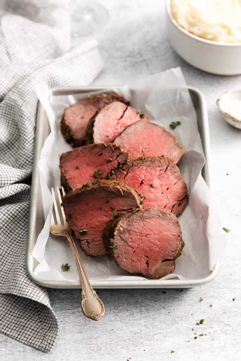 slices of air fryer beef tenderloin on a tray with a fork