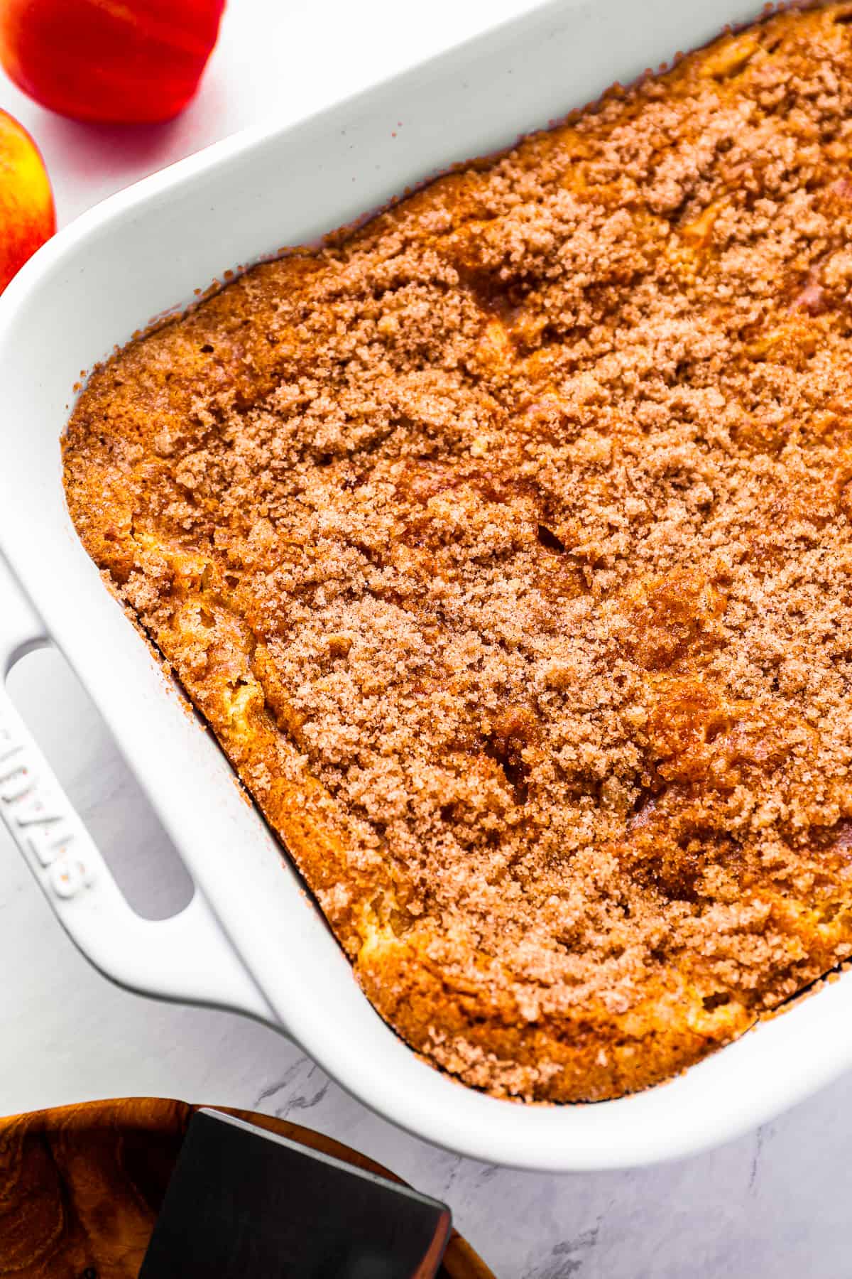 cinnamon apple crumble cake in a white baking dish