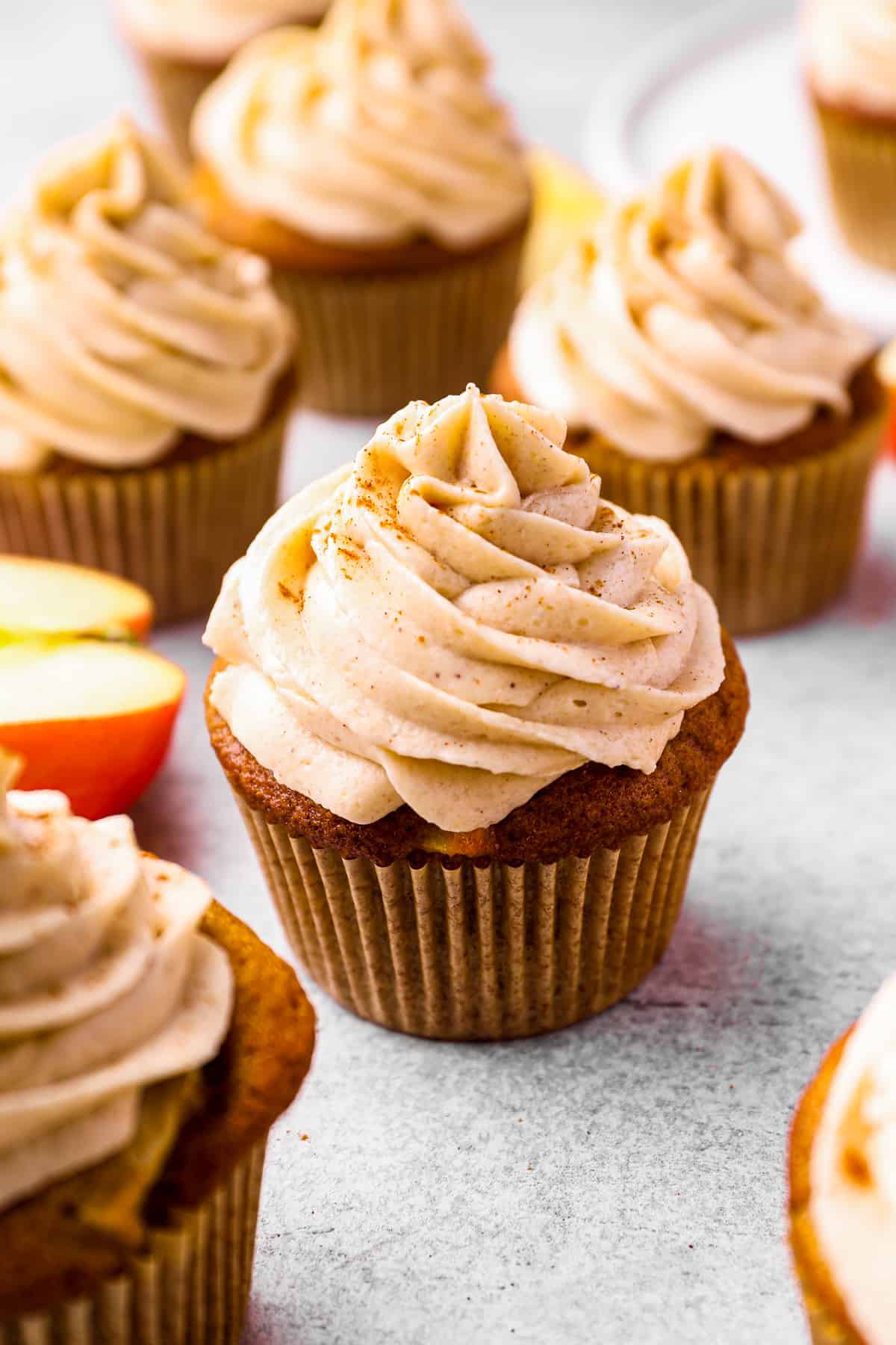 apple cupcakes topped with buttercream frosting