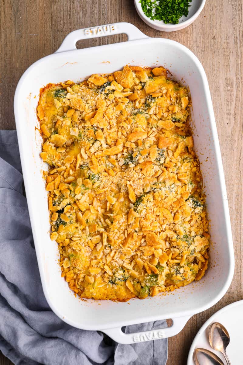 broccoli cheese casserole in a white baking pan.