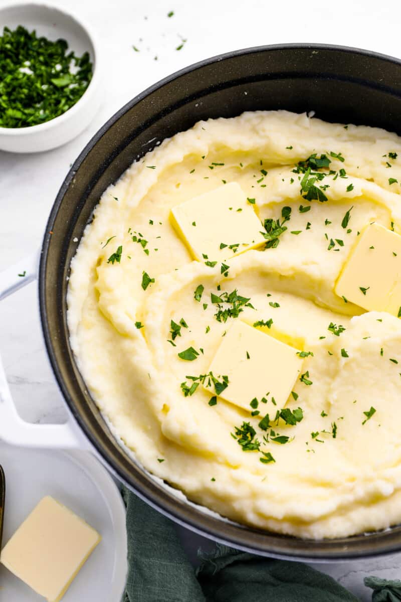 creamy mashed potatoes in a cast iron skillet.