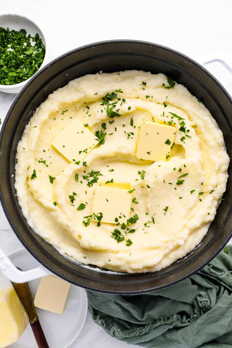creamy mashed potatoes in a cast iron skillet.