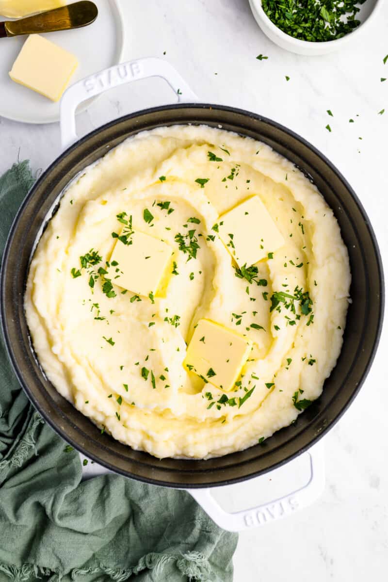 creamy mashed potatoes in a cast iron skillet.