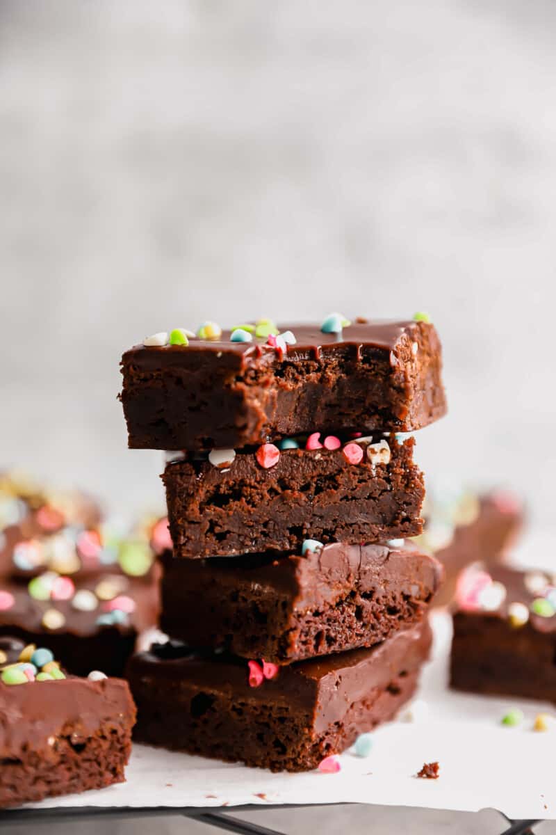 a bitten cosmic brownie atop a stack of 3 cosmic brownies.