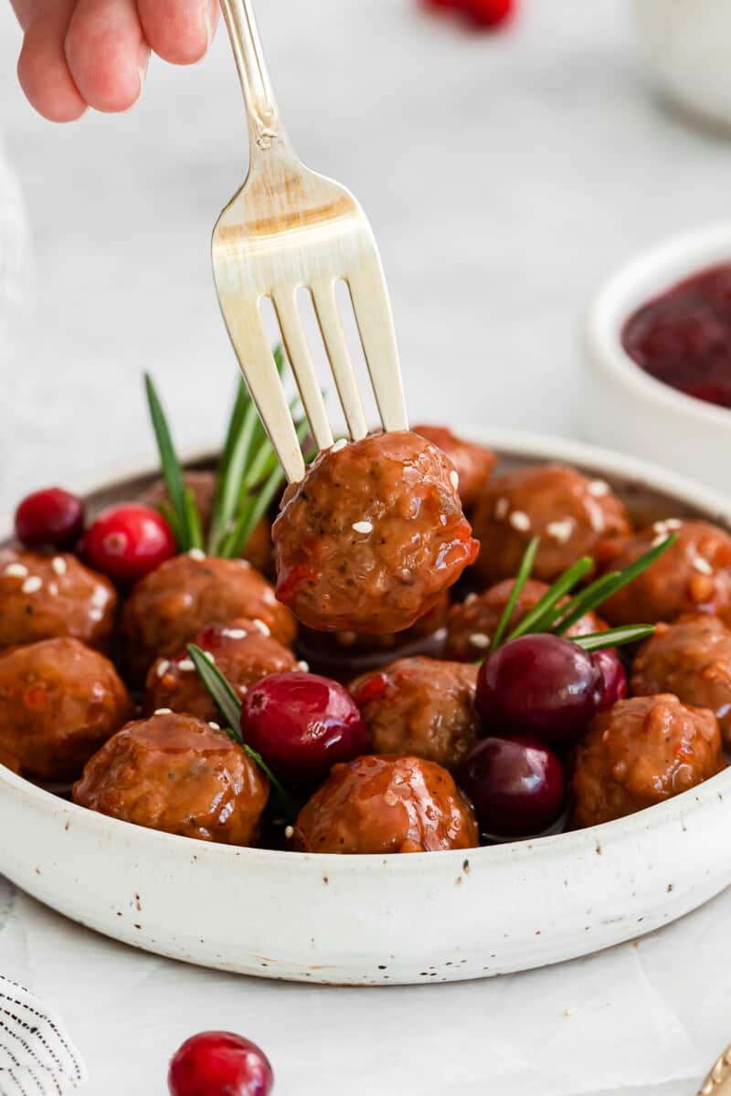 fork poking into a cranberry meatball