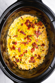 overhead view of crockpot cheesy hashbrown potatoes in a crockpot.