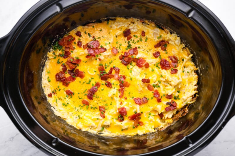 overhead view of crockpot cheesy hashbrown potatoes in a crockpot.