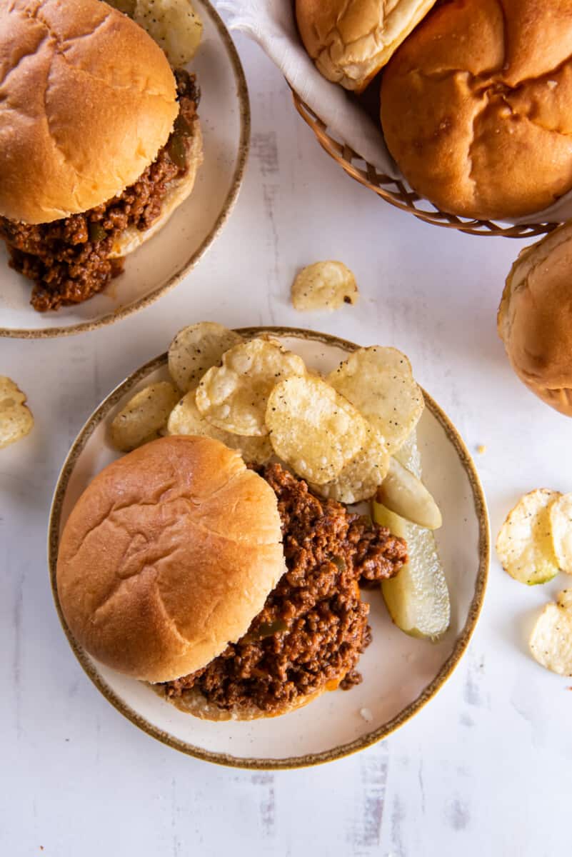 overhead view of plates of sloppy joes with potato chips