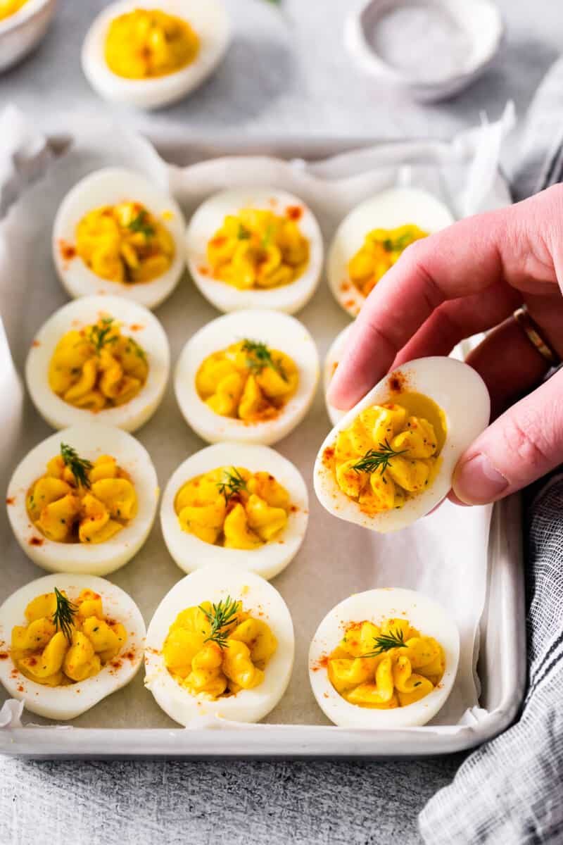 hand picking up an egg from the tray