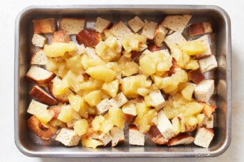 pieces of bread and apples in baking dish