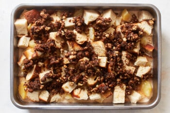 a baking pan filled with sliced bread and nuts.