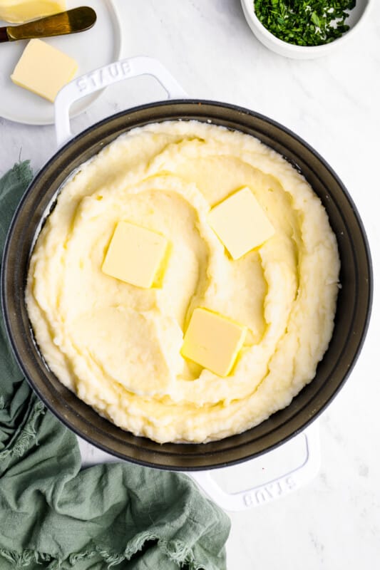 creamy mashed potatoes in a cast iron skillet.