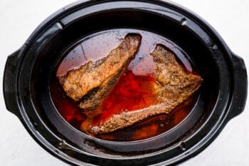 brisket cooking in a slow cooker