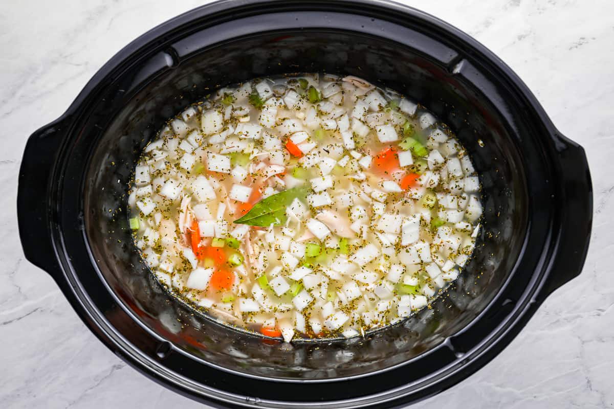 turkey noodle soup ingredients in a crockpot.