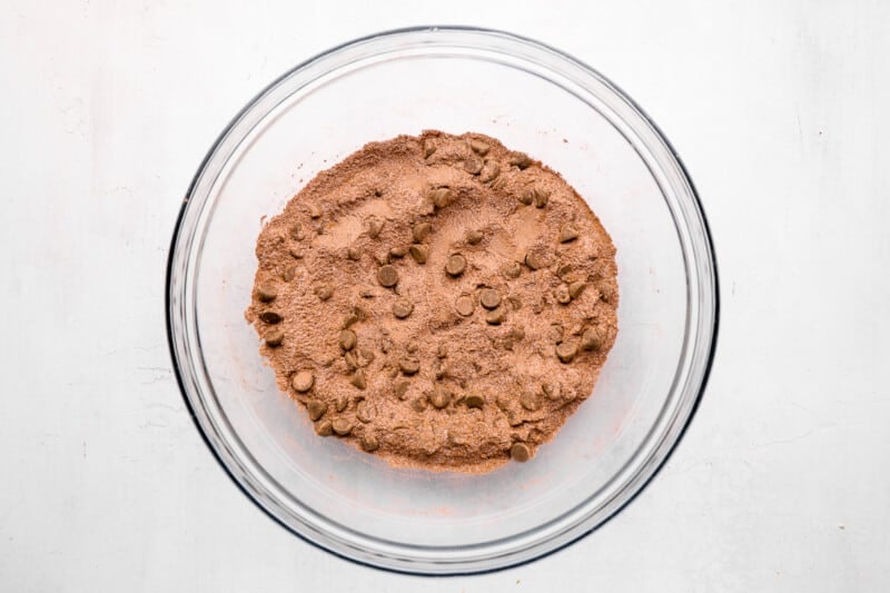 homemade brownie mix in a glass bowl with chocolate chips.