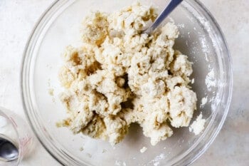 pie dough coming together in a mixing bowl