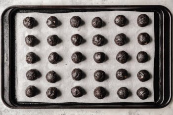 30 oreo balls on a parchment lined baking sheet.