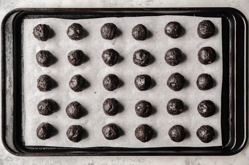 30 oreo balls on a parchment lined baking sheet.