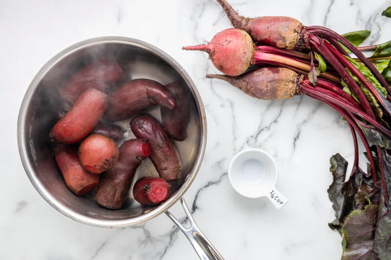 overhead view of boiled beets in a saucepan.