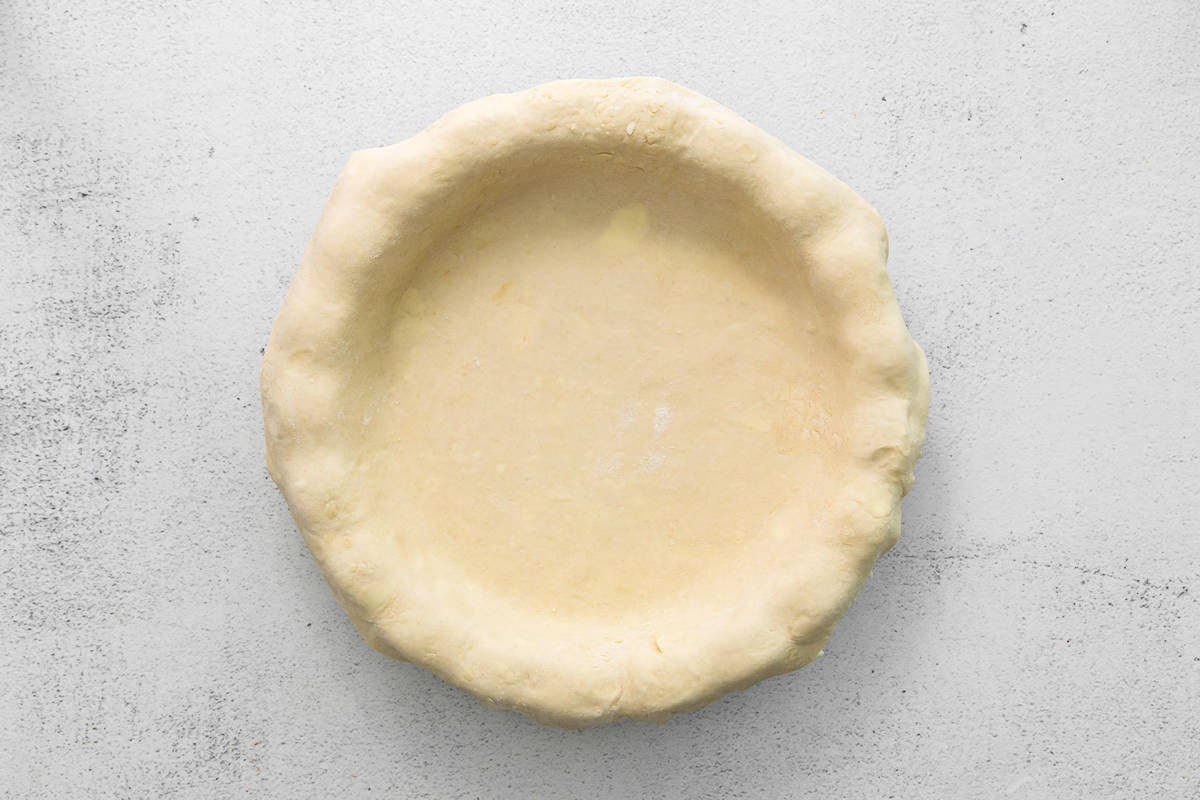 pie dough laid over a pie dish