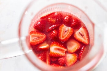 looking into a pitcher of sangria with slices of strawberry