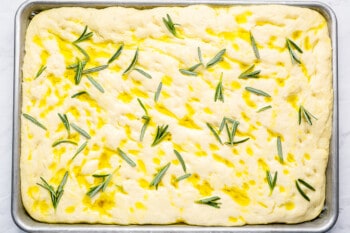 focaccia bread dough topped with rosemary and olive oil