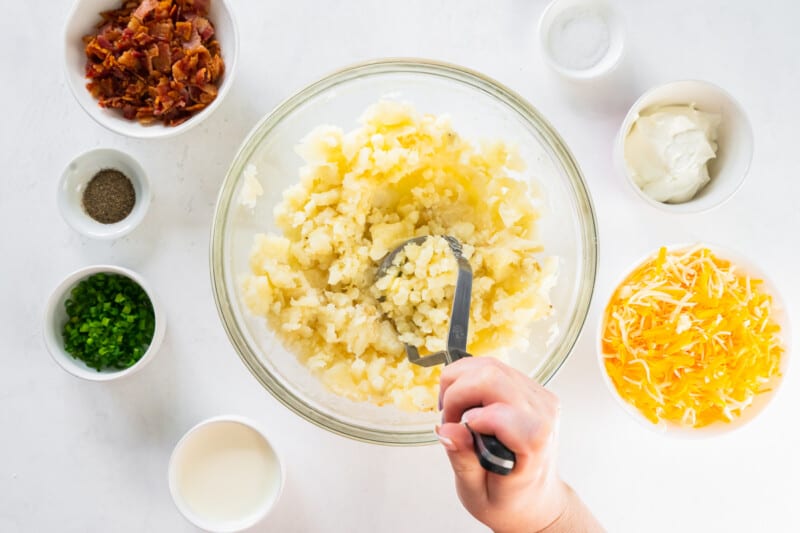 mashing up potatoes with a potato masher