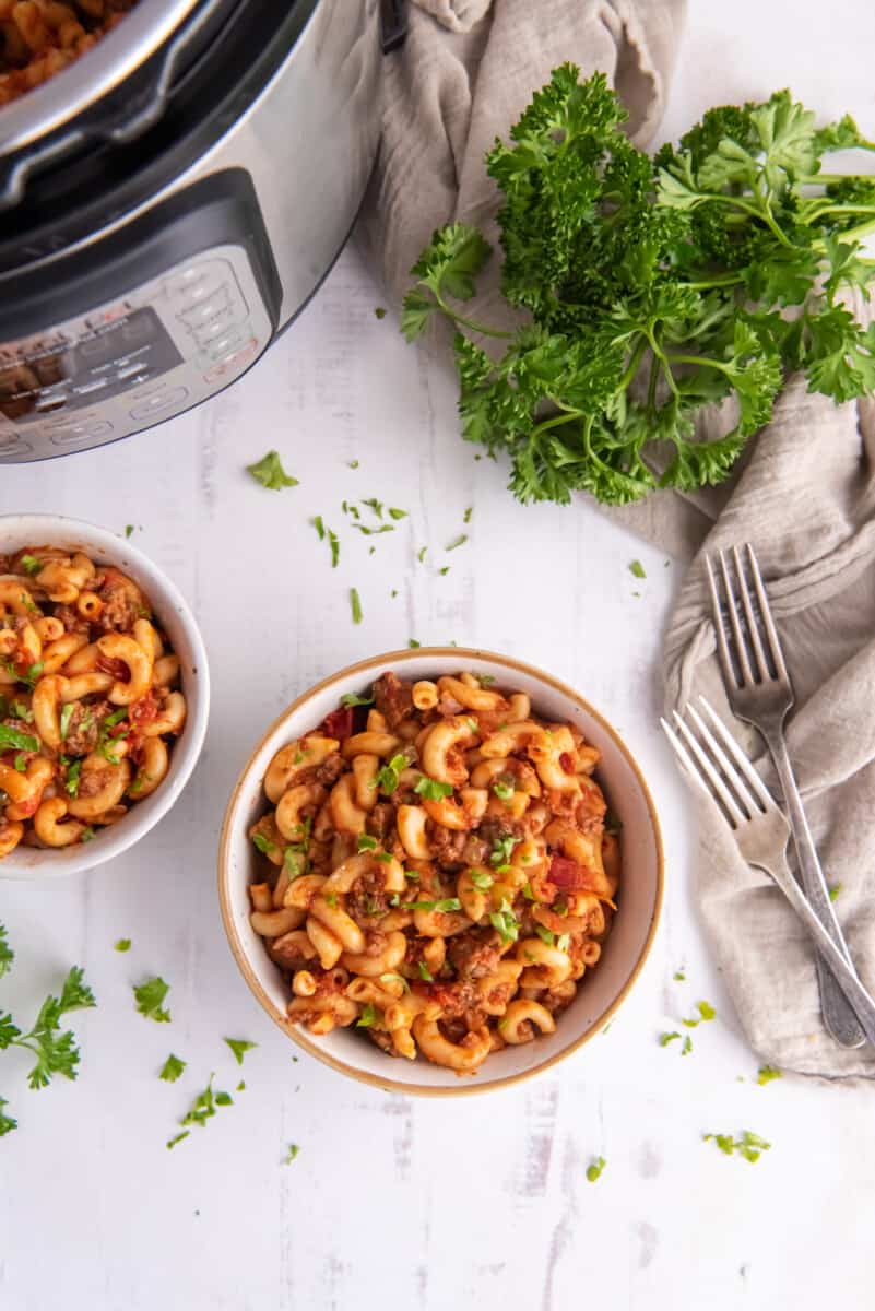 bowls of goulash next to an instant pot