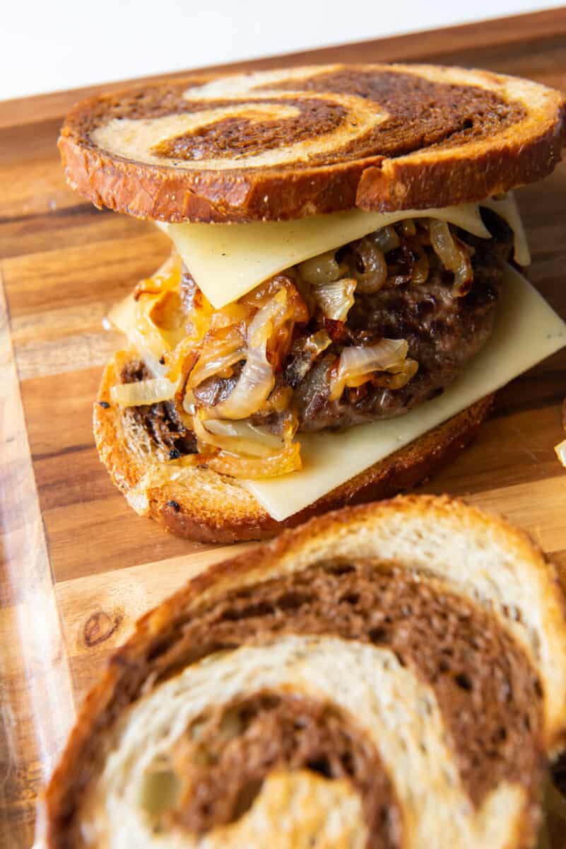 patty melts with Swiss cheese and onions on rye bread