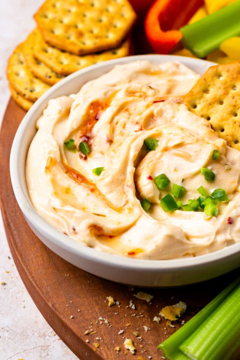 a bowl of creamy hot pepper jelly dip
