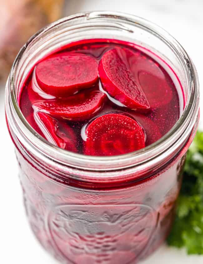 pickled beets in a wide mouth glass jar.
