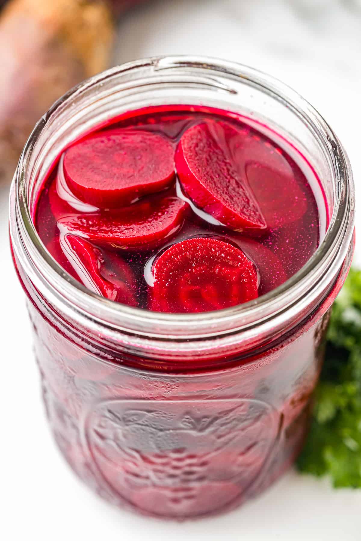 pickled beets in a wide mouth glass jar.
