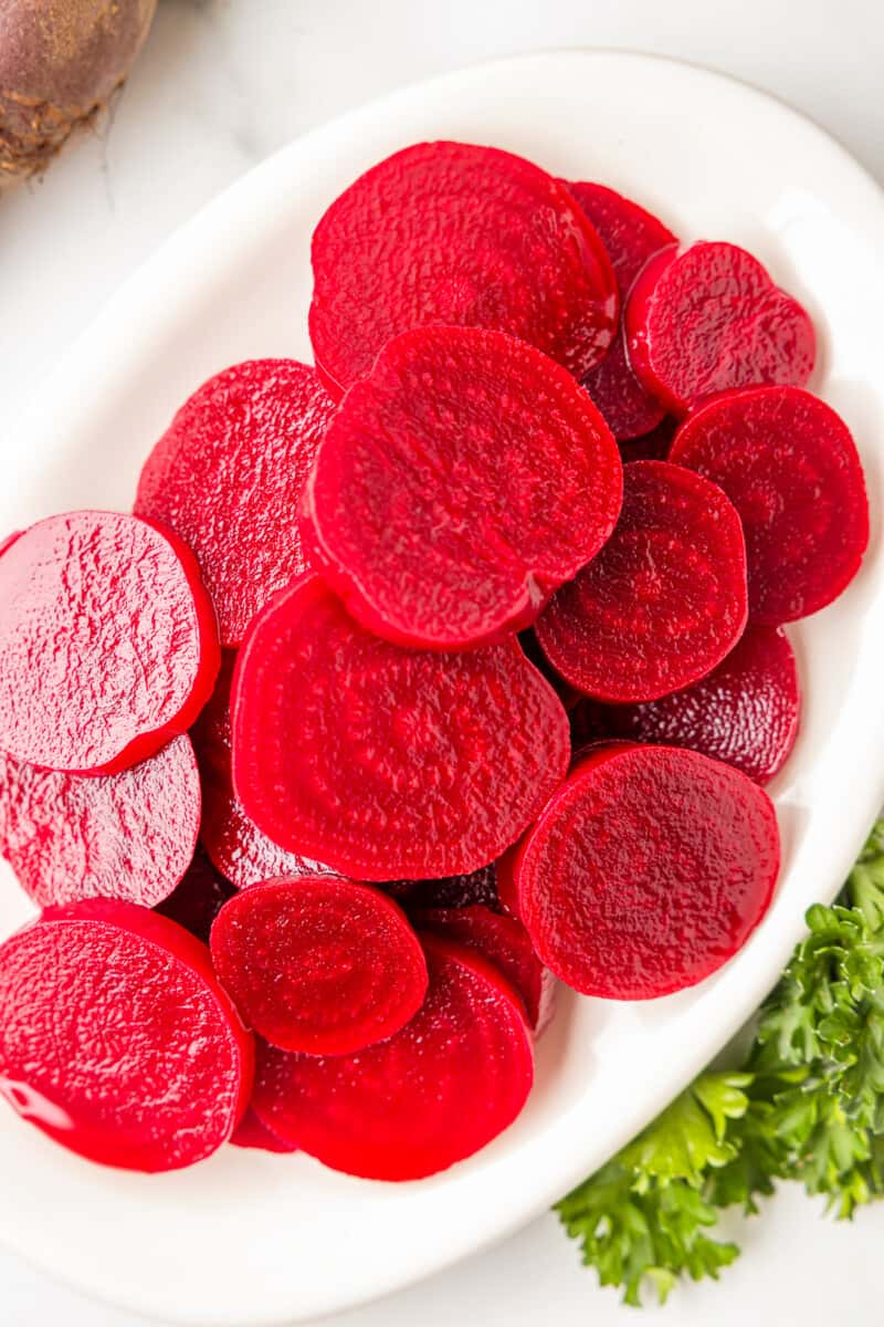 pickled beets on a white serving tray.