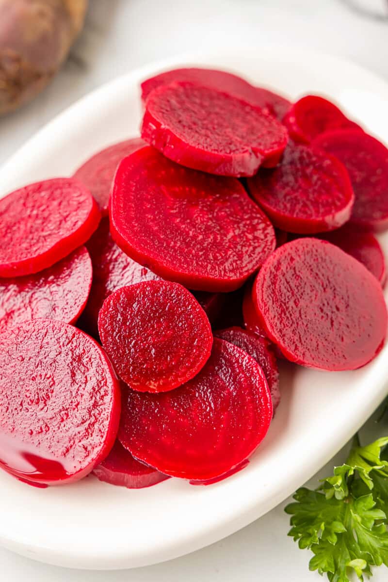 pickled beets on a white serving tray.