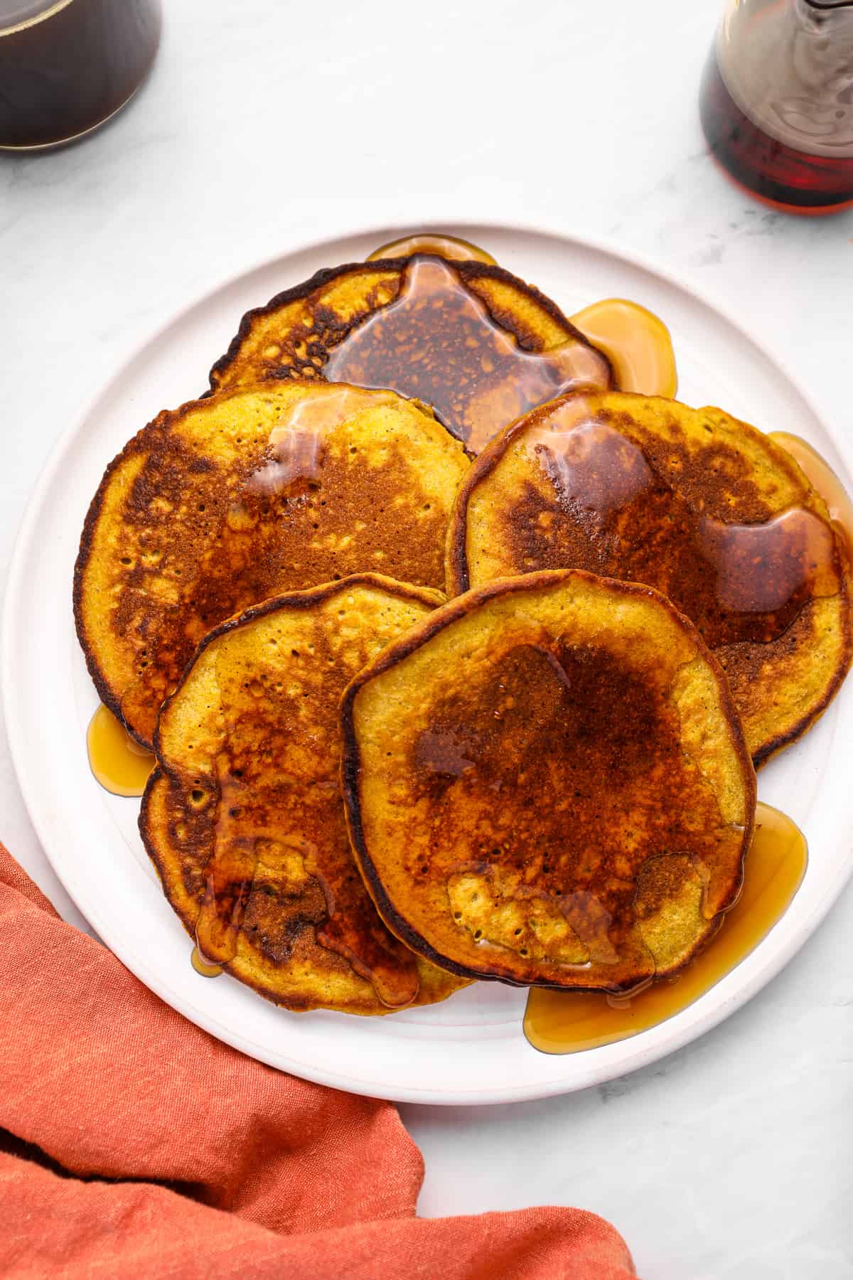a plate of pumpkin pancakes with syrup