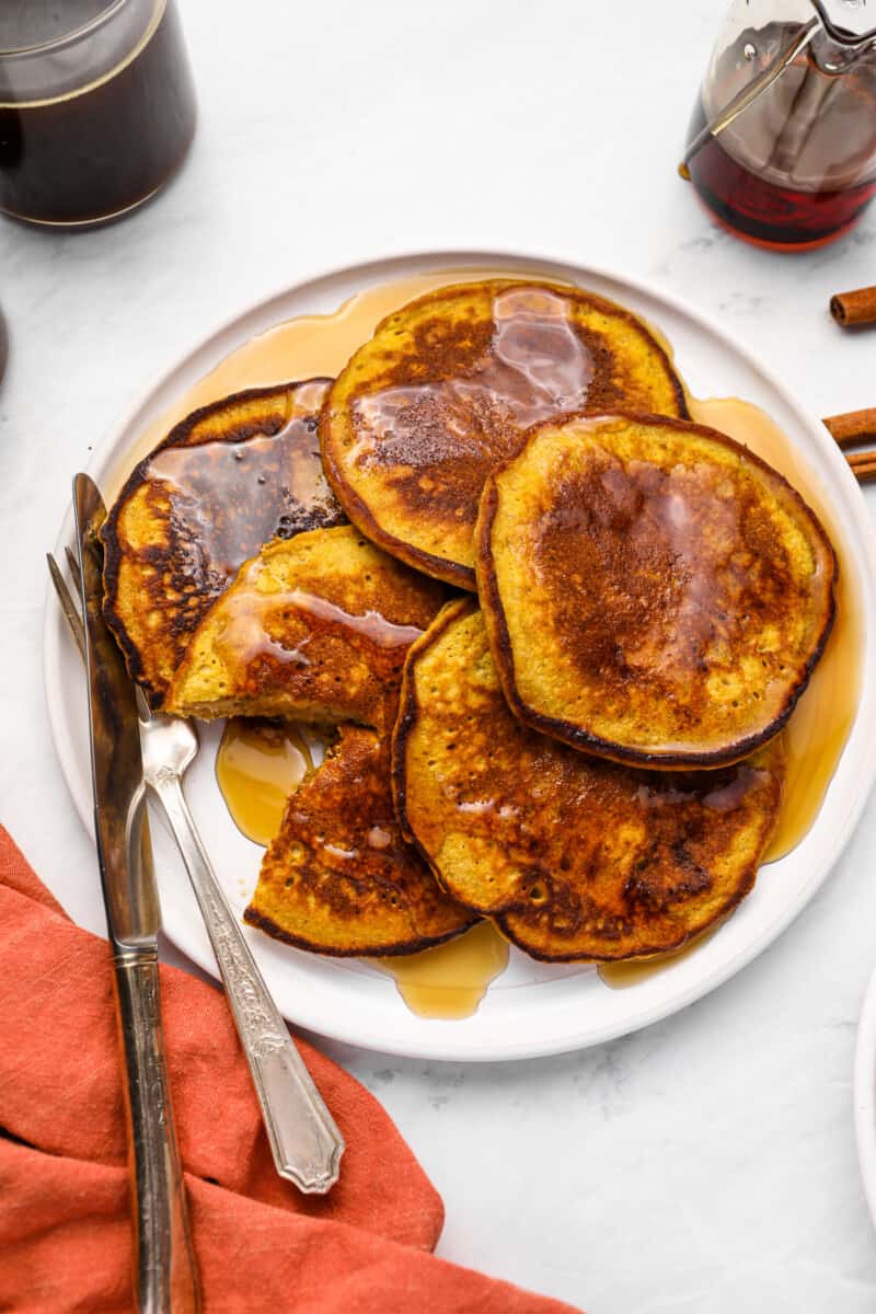 a plate of pumpkin spice pancakes covered in syrup