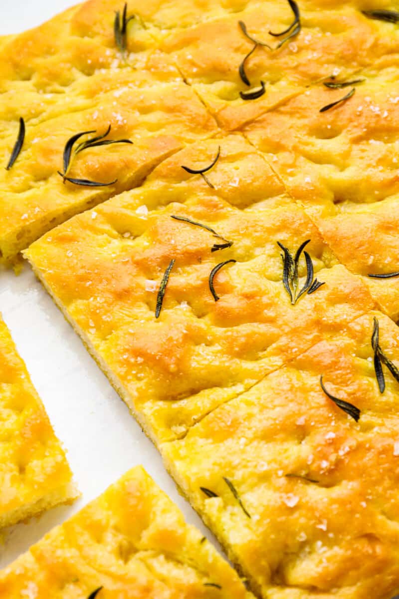 close up on rosemary focaccia bread cut into squares