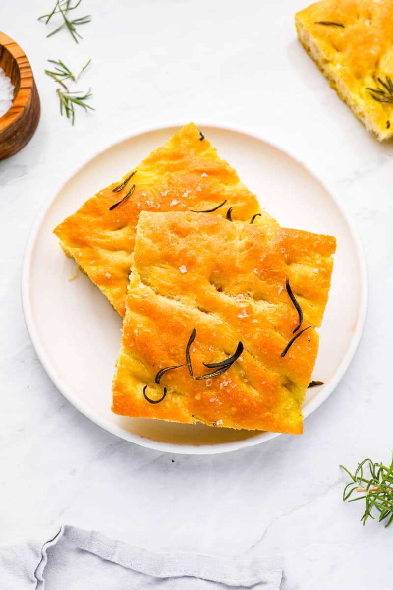 two pieces of rosemary focaccia on a plate