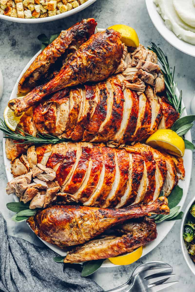 roast thanksgiving turkey, carved and sliced on a serving platter