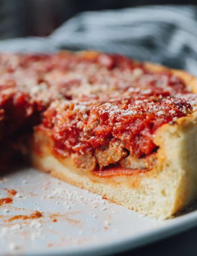 close up of a sliced chicago deep dish pizza.