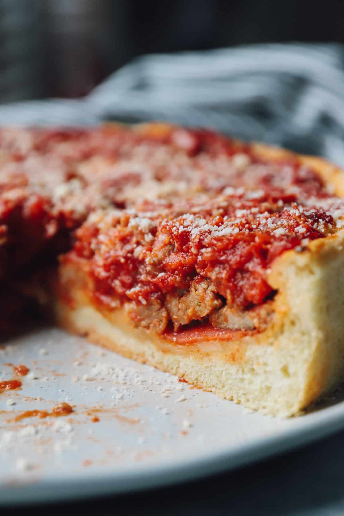 close up of a sliced chicago deep dish pizza.