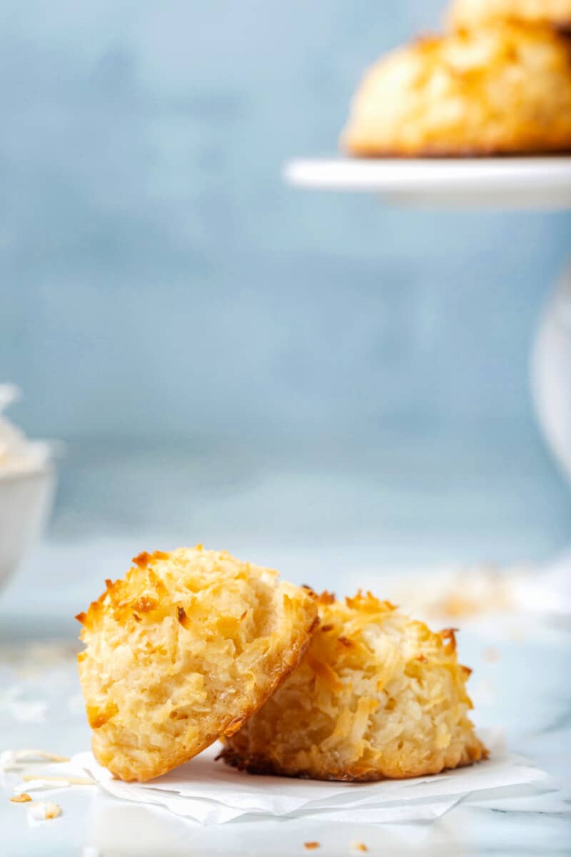 a coconut macaroon leaning against another coconut macaroon.