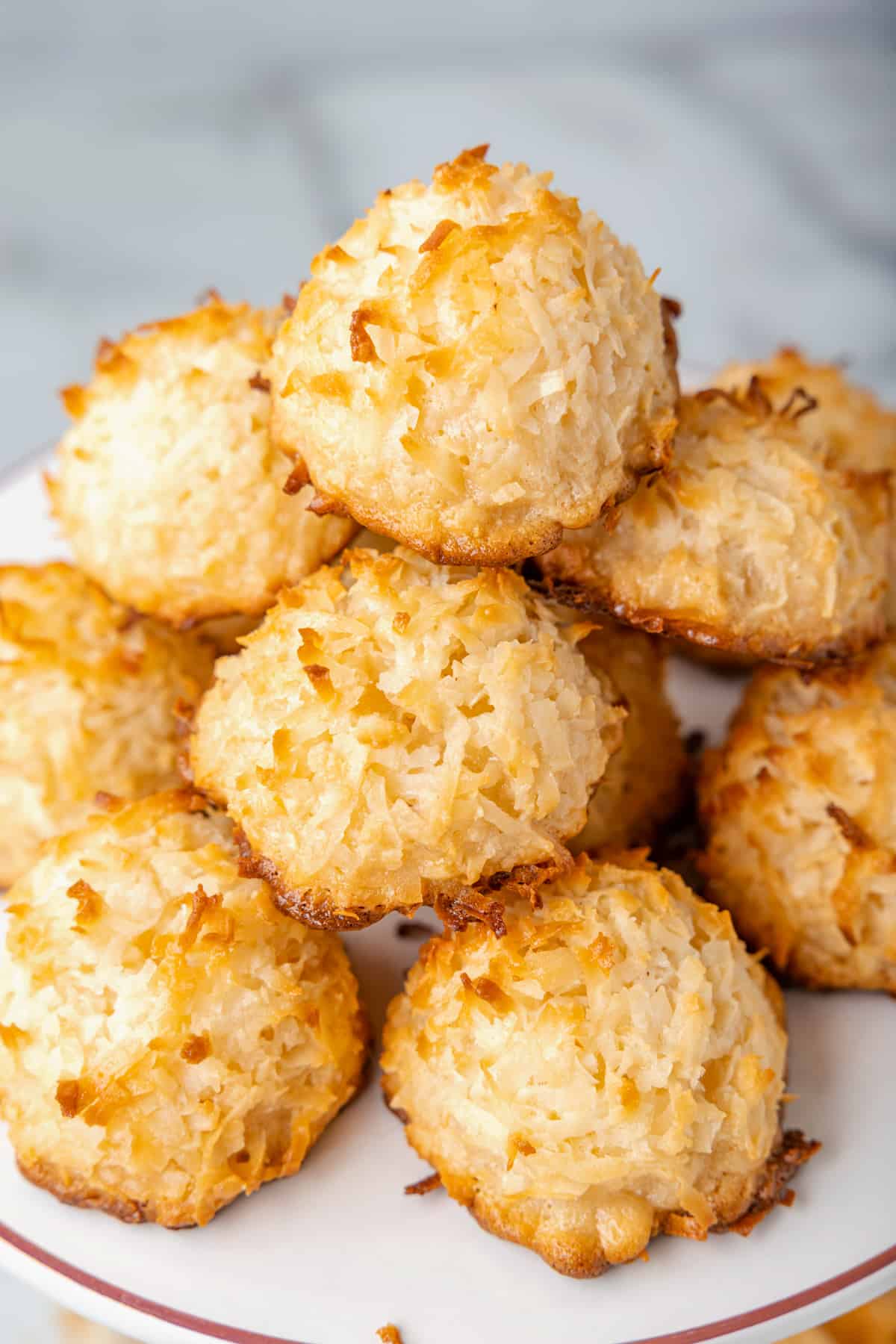 a pile of coconut macaroons on a white plate.