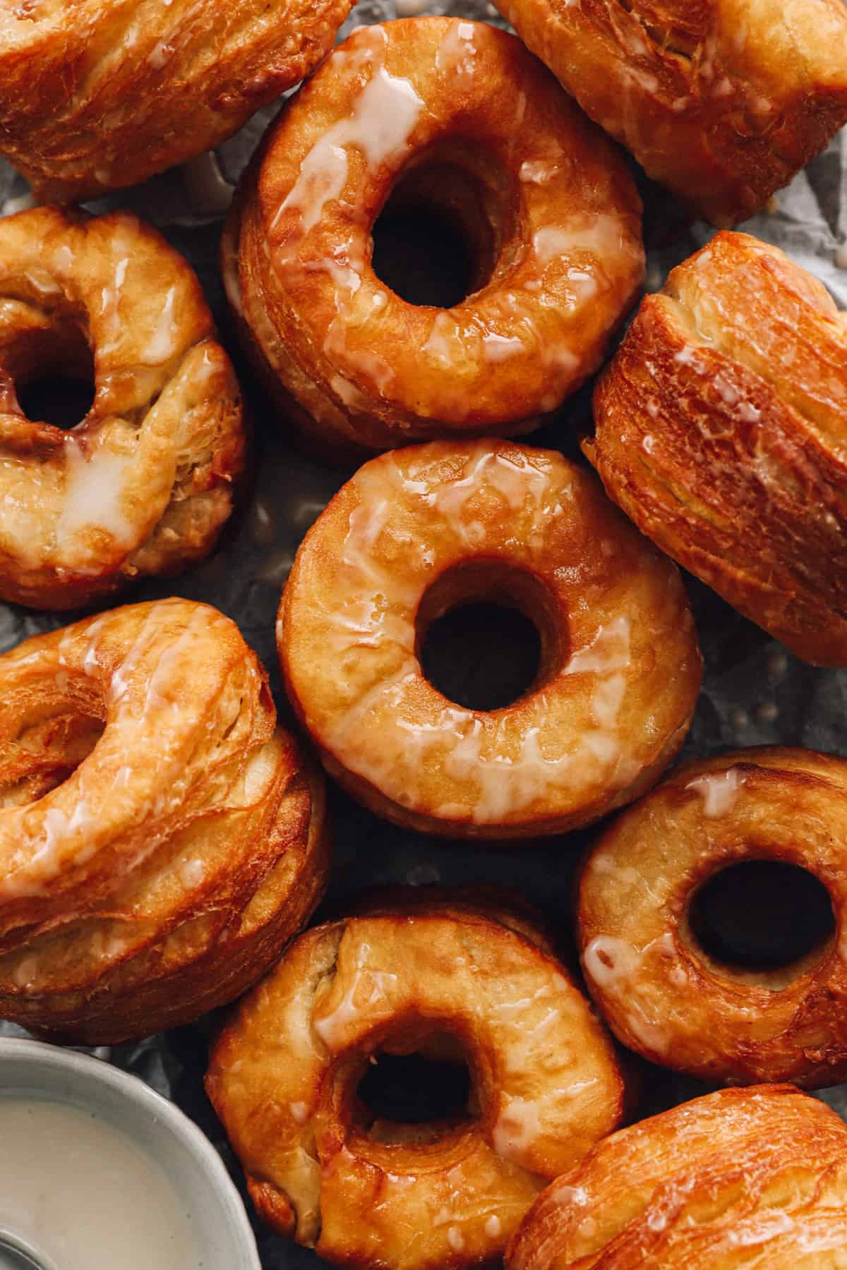 close up of 10 cronuts on a baking sheet.
